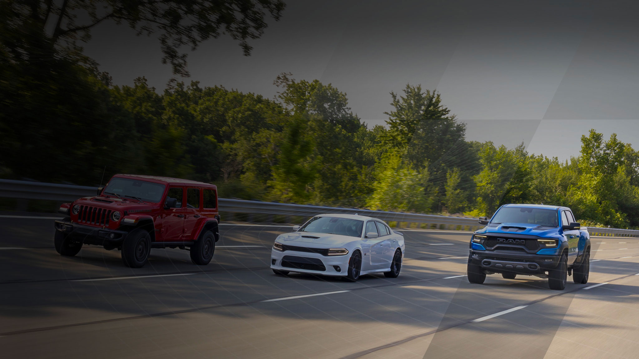 three cars driving on a road