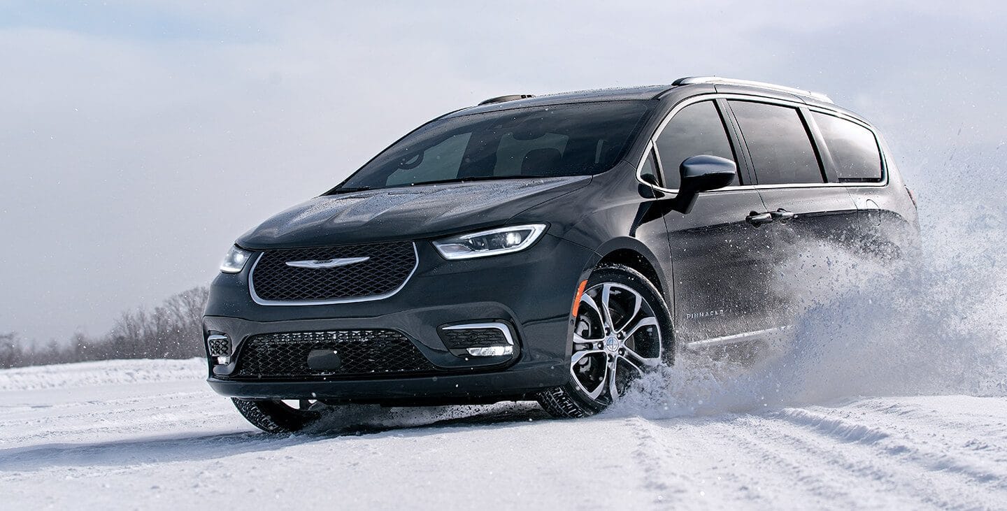 Red Chrysler driving on snow