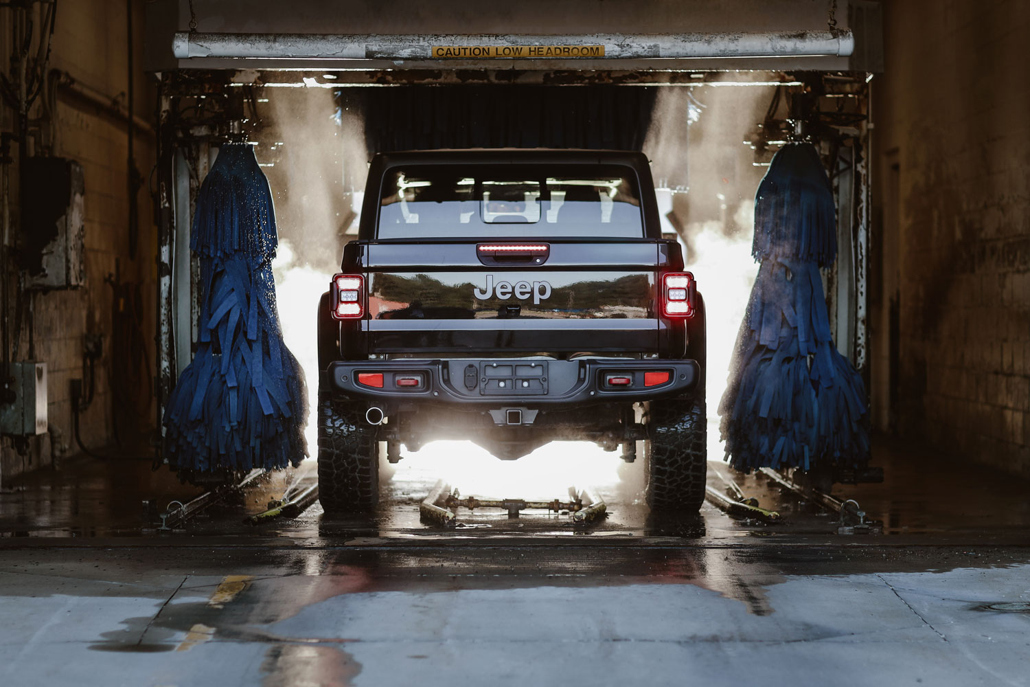 Image of a black Jeep in the car wash