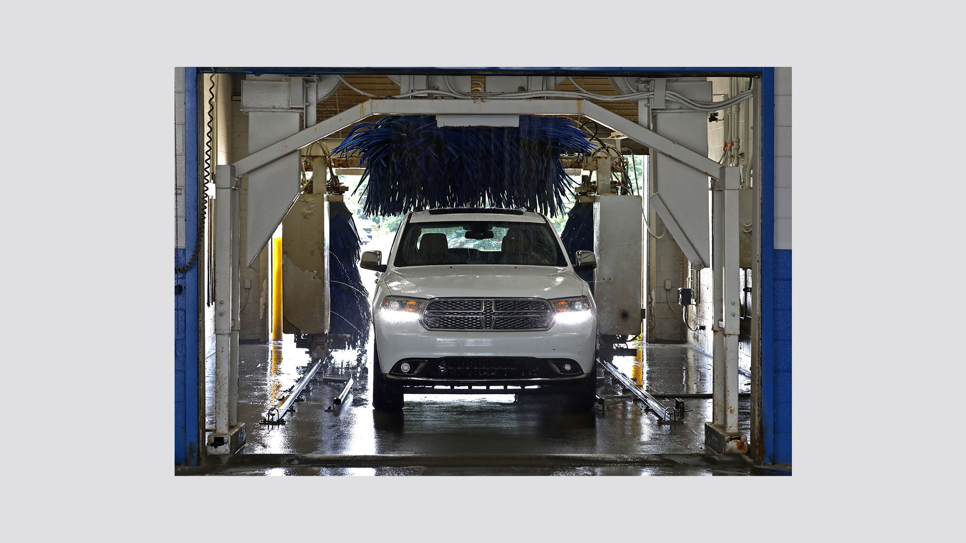 Image of white Dodge in the car wash